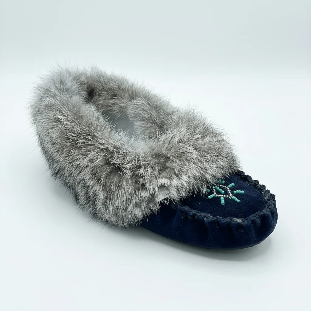 Pair of navy slippers with gray fur trim on a white background